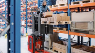 Example image of three Linde high-lift order pickers in a high shelving warehouse.